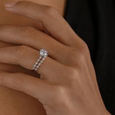 a woman's hand with a diamond ring on it