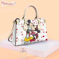 Mickey And Minnie Lovely Disney’s Leather Handbag Introducing our Women’s Handbag, the epitome of sophistication and versatility. Crafted with premium materials and exquisite attention to detail, it offers both style and functionality. With spacious compartments and elegant design, our handbag seamlessly transitions from day to night, adding a chic touch to any outfit. Elevate your... Chanel Shoulder Bag, Leather Handbags Women, Women Handbag, Mickey And Minnie, Disney Style, Everyday Items, Mickey Minnie, Hottest Trends, Metal Buckles