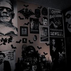 black and white photograph of halloween decorations on the wall in a room with posters above