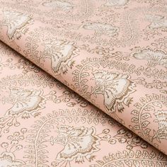 a pink and gold wallpaper with an intricate design on it's surface,