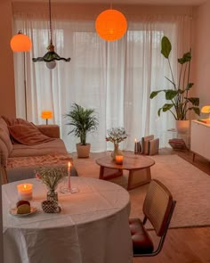 a living room filled with furniture and lots of candles on the table next to a window