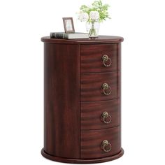 a wooden cabinet with drawers and flowers on top