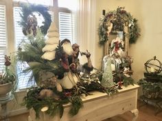 a table with christmas decorations on it in front of a window