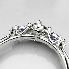 a close up view of a diamond and blue sapphire ring