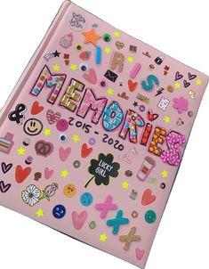 a pink notebook covered in lots of different types of magnets on it's cover