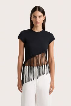 A fitted 100% cotton jersey tee with a high-cut neckline, cropping just above the waist. It features handwoven macrame detailing and fringe, falling diagonally across the torso. Style with the Cassis Pant for an effortless everyday. Fringe Tee Shirt, Cut Up Tees, Upcycle Inspiration, Cut Up T Shirt, Fringe Tshirt, Spiritual Fashion, Slim Fit Crop Top, Cut T Shirt, Maxi Dress Sale