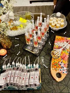 a table topped with lots of cupcakes and drinks