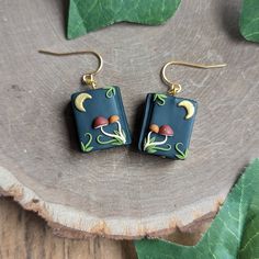 a pair of earrings on top of a tree stump