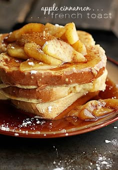 a stack of french toast topped with apple slices and powdered sugar on a plate