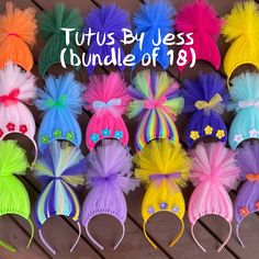 there are many different colored hair accessories on the wooden floor with words tutus by jess bundle of 19