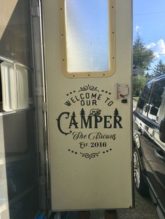 a camper door with the words welcome to our camper on it