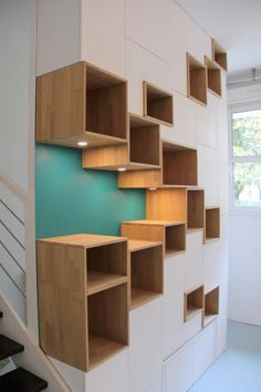 the stairs are made out of wood and have shelves on them