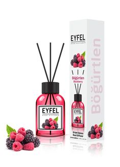 a bottle of eyfel cologne next to raspberries and blackberries