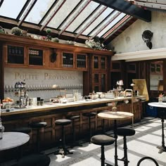 the interior of a restaurant with tables and stools