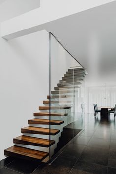 the stairs are made of glass and wood