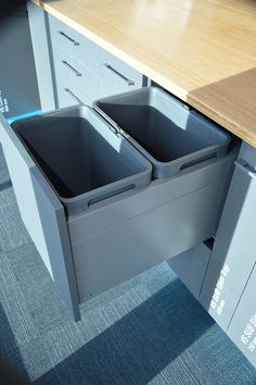 an office desk with two bins on the top and one in the bottom drawer