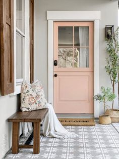 a pink front door and window in a house