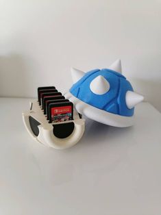 a blue and white object sitting on top of a table next to a card holder