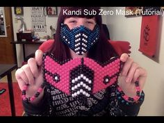 a woman wearing a mask made out of beaded beads with the words kandi sub mask