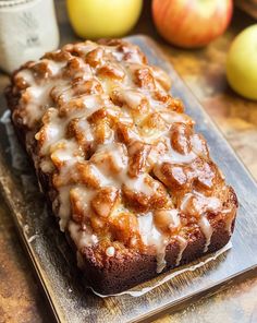 a loaf of cinnamon apple bread sitting on top of a cutting board