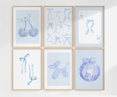 four blue and white pictures hanging on the wall next to each other in different frames