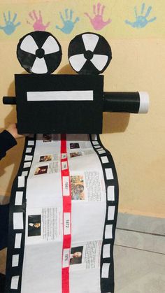 a paper roll robot made to look like it's holding a rolled up newspaper