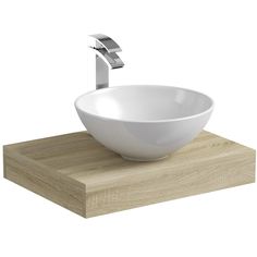 a white bowl sitting on top of a wooden counter next to a faucet