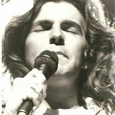 a man holding a microphone up to his mouth