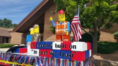 a parade float decorated with legos and ribbons