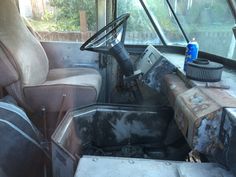 the interior of an old truck with dirty seats