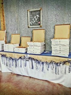 a table topped with lots of pizza boxes