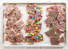 two trays filled with different types of candy and crackers on top of each other