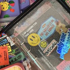 an assortment of stickers and magnets in a plastic case on top of other items