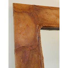 a wooden frame with some brown paint on it