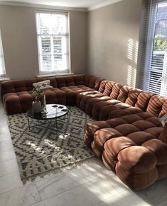 a large sectional couch sitting in the middle of a living room