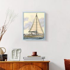 a sailboat floating on top of the ocean next to a wooden cabinet