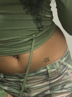 a woman's stomach with a small star tattoo on her lower belly and bottom