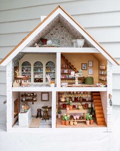 a doll house with furniture and accessories inside