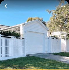 a white fence with a house in the background