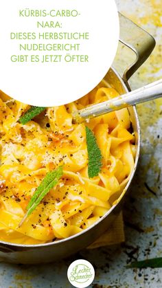 a pot filled with pasta and topped with herbs