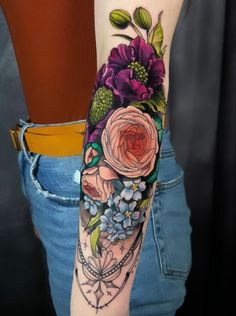 a woman's arm with flowers on it