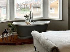 a bathroom with a tub and windows in it