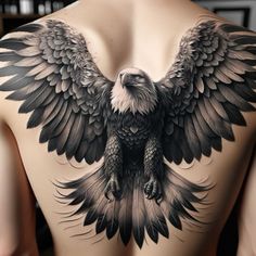 an eagle tattoo on the back of a man's upper body, with wings spread out