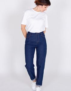 a woman in white shirt and blue jeans