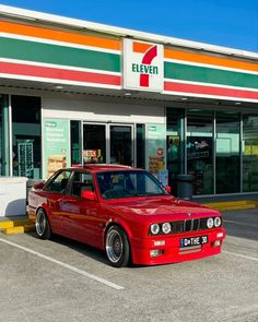 a red car parked in front of a store