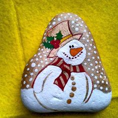 a painted rock with a snowman on it