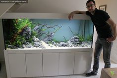 a man standing in front of an aquarium