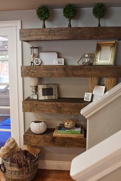 the shelves are made out of wood and have pictures on them