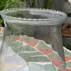 a glass vase sitting on top of a table