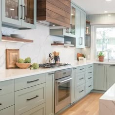 a kitchen with marble counter tops and green cabinets